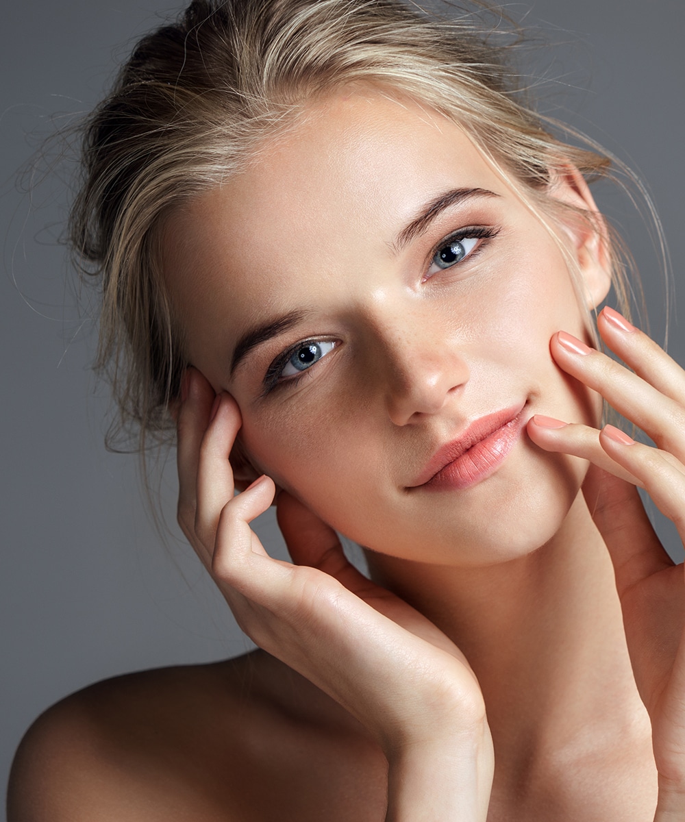 Attractive young girl touching her lips. Photo of blonde girl wi Dental Fillings In Bristol